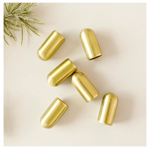 Close-up of six gold bullet-shaped metal cord ends for Christmas tree hanging ornaments