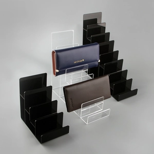 Multi-tier acrylic wallet display stands in clear and black finishes for shelf organization
