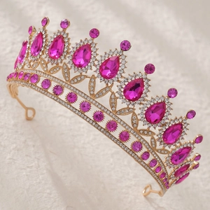 Detailed side view of golden bridal tiara with rhinestones and rose red waterdrop crystals