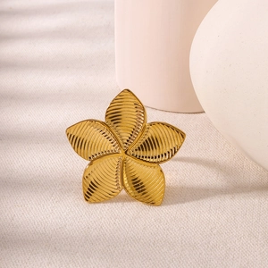 Minimalist golden flower ring with textured petals in a bohemian geometric design