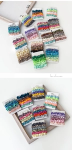 Detail view of satin scrunchies in Morandi colors on cardboard packaging sets
