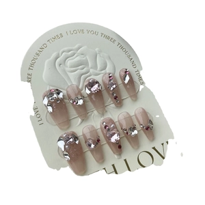 Pink gradient press-on nails with heart rhinestones and pearls on display card
