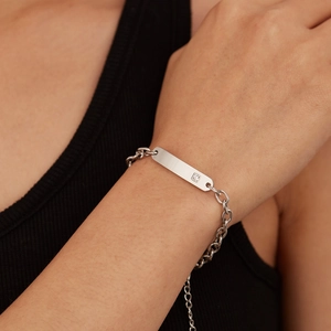 Silver stainless steel NK chain bracelet with a polished ID bar and small zircon stone