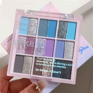 Macro shot of a 16-color palette with blue and purple matte and shimmer eye shadows