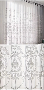 Detail view of white semi-sheer tulle curtain with European Damascus floral embroidery