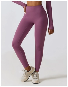 Detail view of high-waist purple yoga leggings with thumbhole sleeve sports top