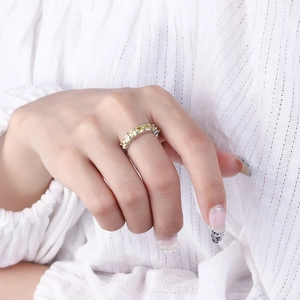 Silver wide-band ring featuring square yellow zircon stones shown on model's hand