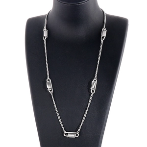 Silver spring pendant necklace in titanium steel on a black mannequin display