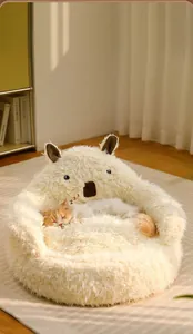Cozy alpaca-shaped pet bed featuring soft plush material and a sleeping cat in warm white