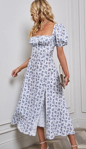 Detail des blauen Blumendrucks auf weißem Kleid mit Puffärmeln und Kordelzug am Ausschnitt