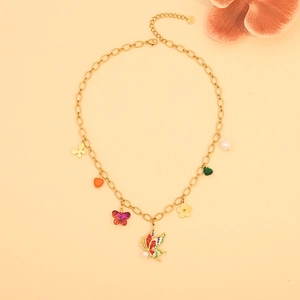 Detail of gold stainless steel necklace with butterfly, heart and pearl charms