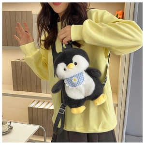 Detailed view of penguin plush backpack featuring a blue plaid bib with flower embroidery
