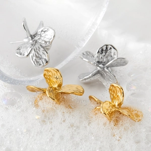 Textured butterfly earrings in gold and silver finish with elegant hammered metal surface