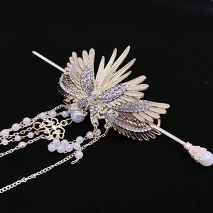 Elegant Chinese wing hair pin with pearl tassels and crystal accents on black velvet
