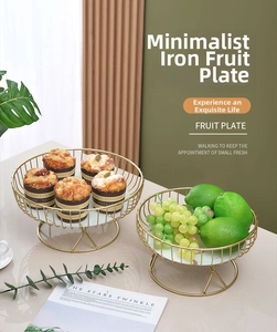 Detail of luxury gold wire tiered fruit trays with white marble base on dining table