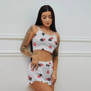 Detail of grey knitted pajamas with heart print and ruffled hem on shorts for women