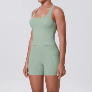 Detail view of sage green yoga set showing side pockets on high-waist sports shorts