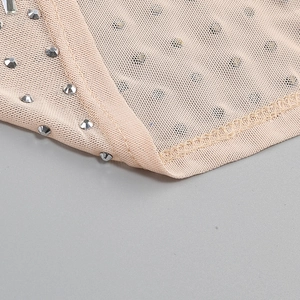 Detail view of pink mesh fabric with sparkling silver rhinestones and premium stitching