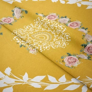 Detail of yellow woven fabric featuring pink rose wreaths and green leaf patterns