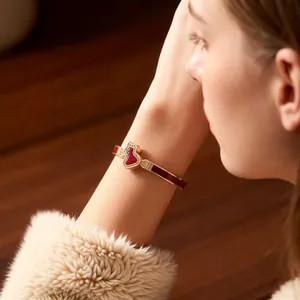 Elegant 18k gold plated C-shaped bangle with red hulu gourd motif and zircon inlay