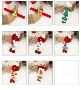 Macro detail of Christmas snap bracelets and hair clips with Santa and reindeer motifs