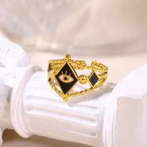 Macro detail of gold evil eye adjustable ring on a white miniature column pedestal
