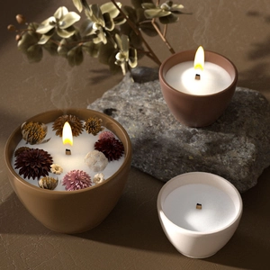 Three soy wax candles in ceramic bowls with wooden wicks and dried flower petal decor
