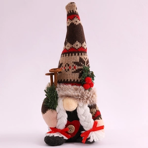 Close-up of a Christmas gnome with knitted hat, white braids, and mini wooden ski poles