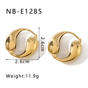 Close-up of chunky gold-plated fluid hoop earrings showing 2.6cm dimensions and mirror finish