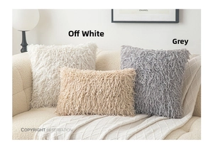 Close-up of plush long-pile cushion covers on sofa in minimalist Nordic interior design