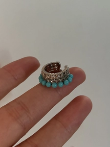 Détail de la boucle d'oreille argentée avec gravures ajourées et petites perles turquoise