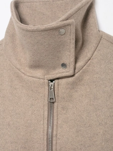 Detail of camel wool bomber jacket featuring a stand collar and metallic zipper closure