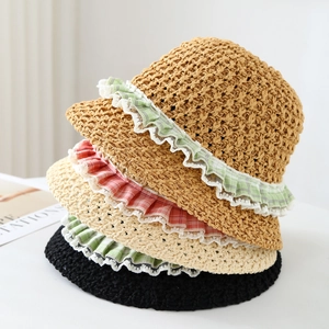 Detail of multi-color straw hats with lace edges and checkered patterns for summer