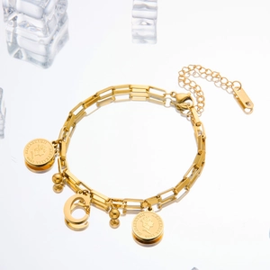 Detail of gold titanium steel coin bracelet with Elizabeth II charm and letter G pendant