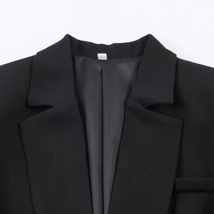 Elegant black slim-fit blazer with ruffled hem and lapel detail for professional women