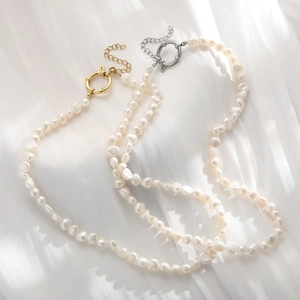 Baroque freshwater pearl necklaces with gold and silver OT toggles on white fabric