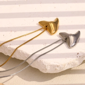 Polished shark tooth geometric pendants in 18K gold and silver plating on stone base