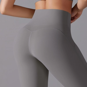 Detailed close-up of high-waist grey yoga pants with push-up stitching for peach butt look
