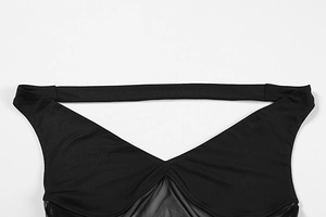 Detailed view of plunging V-neckline with sheer mesh splicing and halter neck design