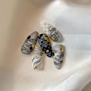 Minimalist nail stickers with ink wash design and 3D embossed gold wave patterns