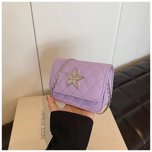 Detail of purple quilted crossbody bag for kids featuring a sparkling rhinestone star