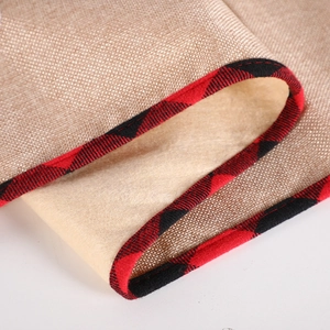 Christmas table runner with reindeer design and red-black checkered border on linen fabric