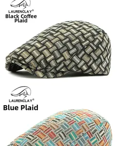 Detail of woven plaid flat caps in black coffee and blue multicolor textured tweed