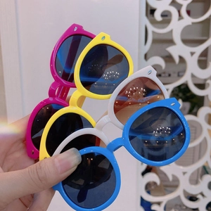 Detailed view of colorful retro round frame children's sunglasses in four bright shades