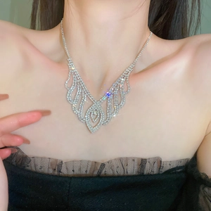 Close-up of sparkling rhinestone tassel necklace with elegant hollow design on model