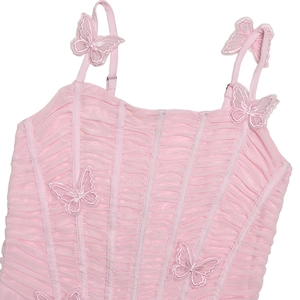 Detailed view of pink camisole with ruched texture, corset seams, and 3D butterfly appliques