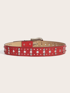 Detail of red leather belt featuring sparkling star-shaped rhinestones and metal eyelets