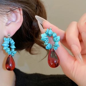 Ethnic style earring with blue stones and a deep red crystal droplet pendant detail