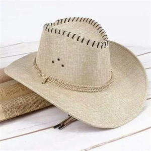 Straw cowboy sun hat with wide brim and decorative rope on a rustic wooden surface