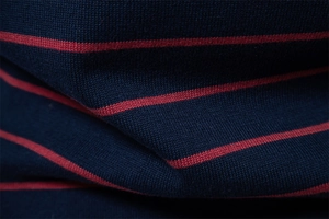 Macro detail of navy and red striped knit sweater showing soft fabric texture and weave